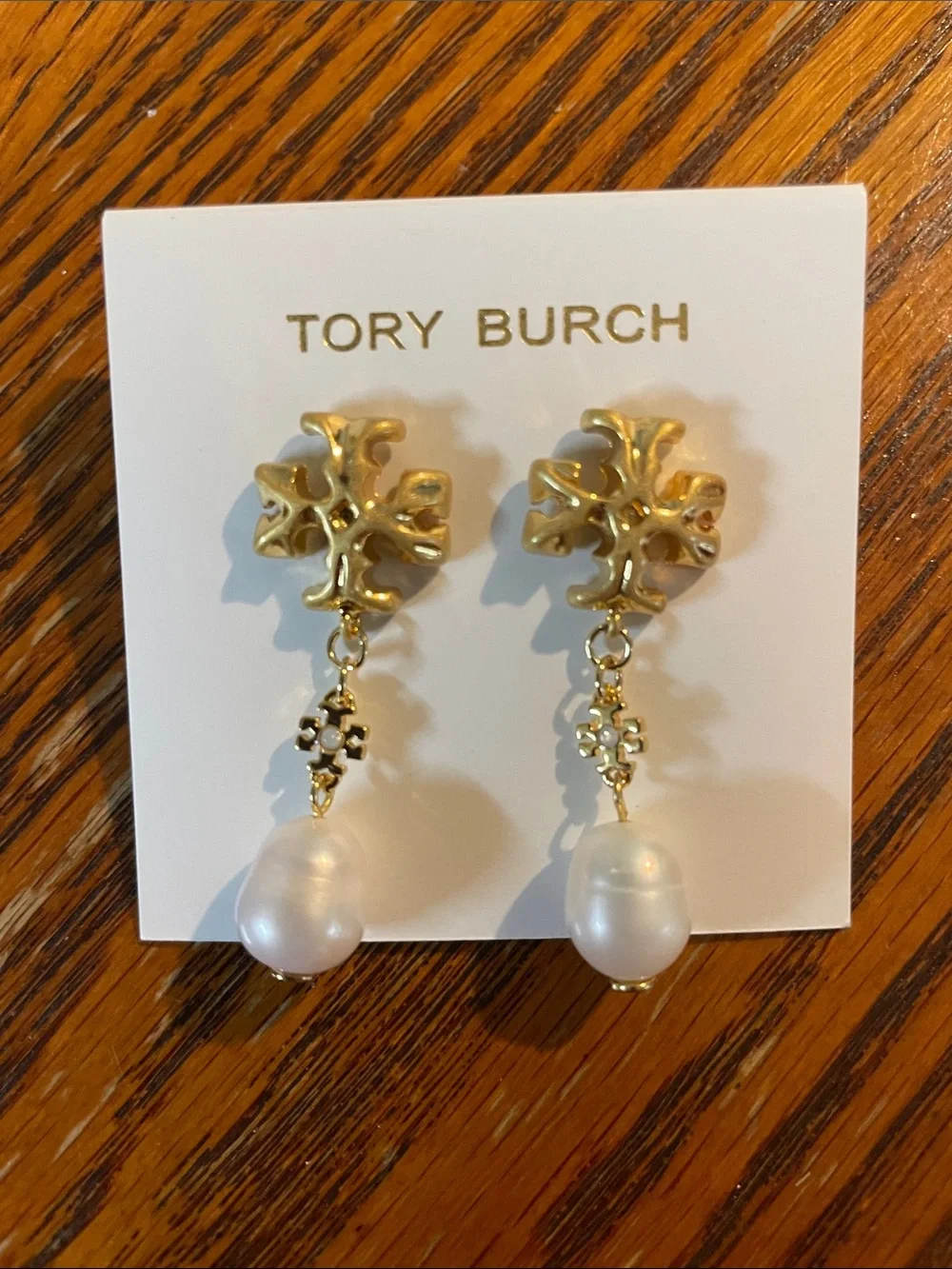 Brand new pearl-drop earrings by Tory Burch.
